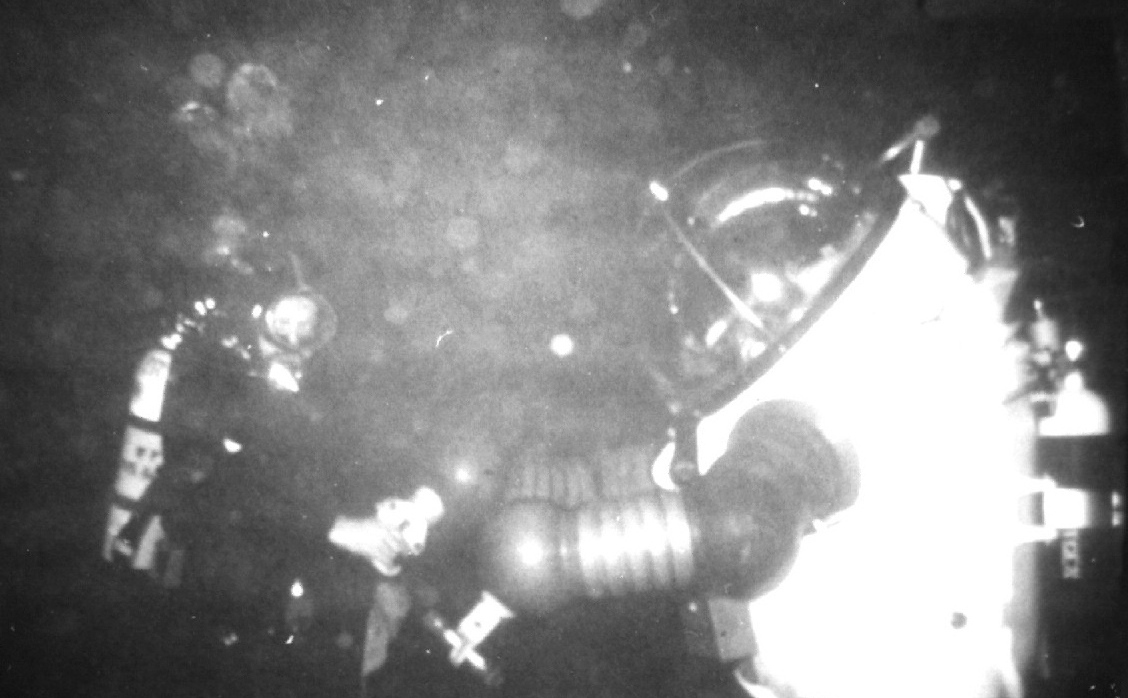 JIM and diver shaking hands underwater